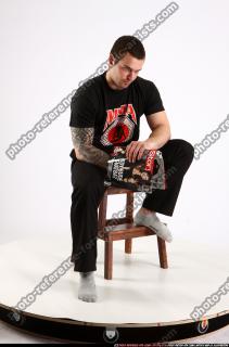 Alex Sitting With Pistol Pose